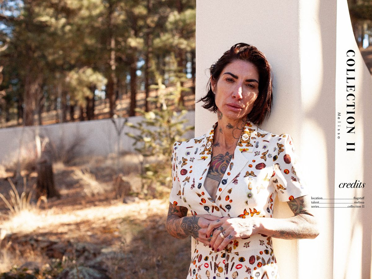 Spread 6 of 6 from Force of Nature: two photographs of a tattooed woman in a printed jacket among trees, beside the collection's title and credits; colour.