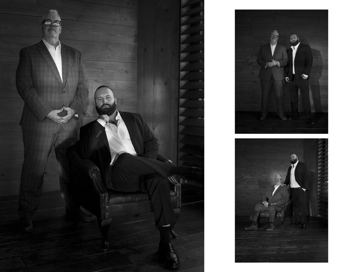 Spread 1 of 2 from Power Moves: two men in suits pose together indoors, one seated in a leather chair; black and white.